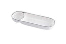 A Pampa Bay Bianca Chip and Dip server is shown on a white background. The dish is elongated and rectangular with rounded ends, designed to hold chips. Attached to one end is a smaller, round bowl for dip. The entire piece is white with a subtle textured appearance and is outlined by a thin, elegant silver rim.
