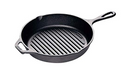 Black cast iron grill pan with raised parallel ridges on the cooking surface and a long handle extending to the right.