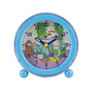 A light blue round Modeh Ani singing alarm clock with a cartoon illustration on the face. The illustration shows a child waking up in bed with a yellow sun shining. Hebrew text "מודה אני" is visible above the child. The clock has yellow hour and minute hands, a red second hand, and black numbers.