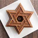 Silver-toned metal baking mold in the shape of the Star of David with central opening.