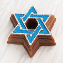Silver-toned metal baking mold in the shape of the Star of David with central opening.