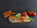 The Original Swiss Peeler by Kuhn Rikon, shown in red, with a durable carbon steel blade for easy vegetable and fruit peeling.
