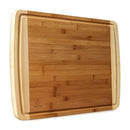 Indigo True Bamboo Cutting Board, a rectangular board with visible bamboo grain, a juice groove around the perimeter, and lighter colored edges.
