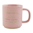 Pink glazed stoneware mug with humorous mom-themed text, displayed on a white background.