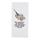 A white Mud Pie Circa Kitchen waffle weave towel featuring an embroidered illustration of a mixing bowl with a whisk and a recipe card. Below the image is black embroidered text that reads: "My cooking is so fabulous even the smoke alarm cheers me on!"