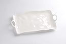 A Pampa Bay Ivy Melamine Large Platter is shown on a white surface. The platter is an off-white color with a gently uneven, organic shape and slightly raised edges. It features integrated circular handles on both shorter ends. The platter has a smooth, matte finish characteristic of melamine.