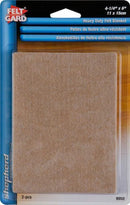 Pack of two Shepherd Hardware Heavy Duty Felt Blankets furniture pads. The pads are beige and rectangular, measuring 4-1/4 inches by 6 inches (11 x 15 cm). The packaging is blue and white with the "Felt Gard" and "Shepherd" logos, and indicates the pads are heavy duty and have adhesive backing.