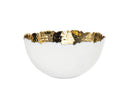 Godinger Munro white ceramic fruit bowl that has a simple, rounded, and slightly shallow shape. The Rim is irregularly shaped with hand-hammered gold interior.