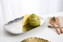 A Pampa Bay Millennium Titanium-Plated Porcelain 11-inch Platter is displayed on a white background. The silver-colored platter features a textured, hammered finish and slightly raised, irregular edges. 