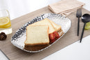 A Pampa Bay Millennium Titanium-Plated Porcelain 11-inch Platter is displayed on a white background. The silver-colored platter features a textured, hammered finish and slightly raised, irregular edges. 