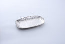 A Pampa Bay Millennium Titanium-Plated Porcelain 11-inch Platter is displayed on a white background. The silver-colored platter features a textured, hammered finish and slightly raised, irregular edges. 