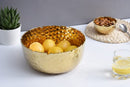 Elegant Pampa Bay Golden Millennium large porcelain round bowl with a richly textured, hammered gold surface inside and out, and an irregular rim.