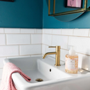 Clear bottle of Greenleaf Cashmere Kiss foaming hand soap with a white pump, featuring a warm floral fragrance and a decorative label.