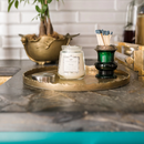 Vintage-inspired clear glass jar candle with a silver lid, labeled "Greenleaf Haven