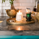 Vintage-inspired clear glass jar candle with a silver lid, labeled "Greenleaf Haven