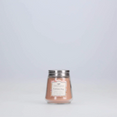 A small, light brown candle from Greenleaf, in the Cashmere Kiss fragrance, presented in a clear jar with a silver lid.