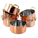 Serving-sized Dutch ovens with a shiny copper exterior, stainless steel interior, and decorative brass-toned handles.