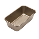 Rectangular baking pan for loaves, featuring a gold-toned non-stick interior and a unique diamond pattern on the bottom.
