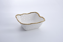 Large square salad bowl in white porcelain with a textured surface and a beaded golden rim.
