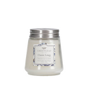 A small, creamy white candle from Greenleaf, in the Fresh Linen fragrance, presented in a clear jar with a silver lid and a blue floral design on the label.