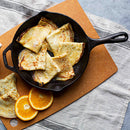 A classic 10.25-inch cast iron skillet, pre-seasoned for a natural, non-stick finish. Designed for even heat distribution, making it ideal for frying, searing, baking, and sautéing. Features a sturdy handle with a helper grip and dual pour spouts for easy handling. Perfect for use on stovetops, ovens, and campfires.