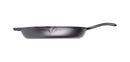 Black cast iron skillet with a long ergonomic handle and helper handle, featuring a smooth cooking surface and dual pour spouts.