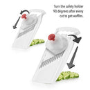 A white mandoline slicer with a large metal blade angled across its surface. The top has a handle with the word "Borner" embossed on it. 