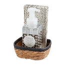 Mud Pie Black Dot Soap & Guest Towel Set featuring a bottle of vanilla liquid foaming hand soap with a black and white circular pattern label, and a stack of guest towels with a black dot design, nestled in a woven basket.