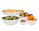 Godinger Munro white ceramic fruit bowl that has a simple, rounded, and slightly shallow shape. The Rim is irregularly shaped with hand-hammered gold interior.