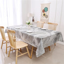 A forest grey jacquard print rectangular tablecloth by Majestic Giftware, neatly spread on a table