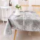 A forest grey jacquard print rectangular tablecloth by Majestic Giftware, neatly spread on a table